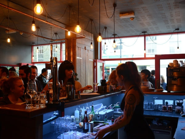 Bar staff member interacting with customers