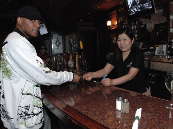 Bartender checking ID of customers